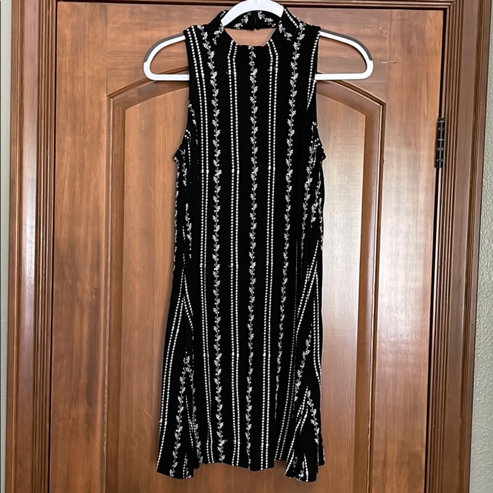 Black dress with white embroidered patterns